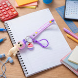 Front view of cute doll and cupcake keychain with rainbow strap accessory