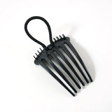 Hair styling comb clip securing hair in a voluminous bun style