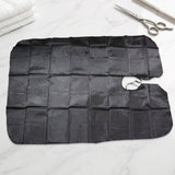 Professional hair cutting apron cape hanging on hook