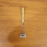 Lifestyle scene showing jeep-shaped metal car keychain in use with keys