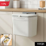 Plastic kitchen dustbin with lid mounted on the wall