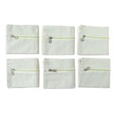Six saree storage zipper pouches arranged for wardrobe organization