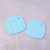 Cup coaster with secure textured non-slip surface for holding hot drinks